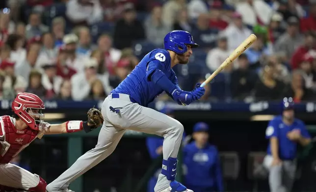 Chicago Cubs' Cody Bellinger follows through after hitting a run-scoring single against Philadelphia Phillies pitcher Taijuan Walker during the second inning of a baseball game, Tuesday, Sept. 24, 2024, in Philadelphia. (AP Photo/Matt Slocum)