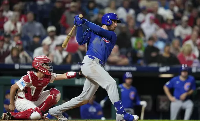 Chicago Cubs' Cody Bellinger follows through after hitting a single against Philadelphia Phillies pitcher Tyler Gilbert during the eighth inning of a baseball game, Tuesday, Sept. 24, 2024, in Philadelphia. (AP Photo/Matt Slocum)