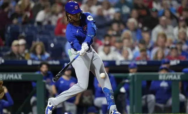 Chicago Cubs' Kevin Alcantara hits a single against Philadelphia Phillies pitcher Carlos Estévez during the ninth inning of a baseball game, Wednesday, Sept. 25, 2024, in Philadelphia. (AP Photo/Matt Slocum)