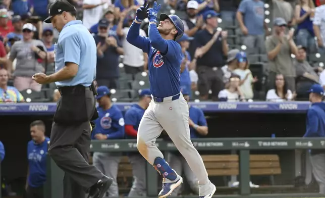 Chicago Cubs' Michael Busch celebrates while running the bases after hitting a one-run home run in the ninth inning of a baseball game against the Colorado Rockies, Sunday, Sept. 15, 2024, in Denver. (AP Photo/Geneva Heffernan)