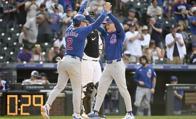 Chicago Cubs' Nico Hoerner and Pete Crow-Armstrong celebrate after Crow-Armstrong's two-run home run in the ninth inning of a baseball game against the Colorado Rockies, Sunday, Sept. 15, 2024, in Denver. (AP Photo/Geneva Heffernan)