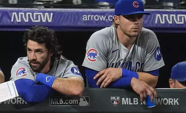 Chicago Cubs shortstop Dansby Swanson, left, and second baseman Nico Hoerner lean on the dugout rail in the ninth inning of a baseball game against the Colorado Rockies, Friday, Sept. 13, 2024, in Denver. (AP Photo/David Zalubowski)