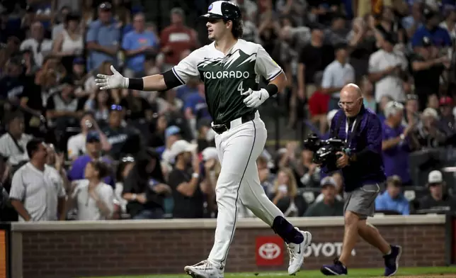 Colorado Rockies' Michael Toglia celebrates after hitting a home run in the seventh inning of a baseball game against the Chicago Cubs, Saturday, Sept. 14, 2024, in Denver. (AP Photo/Geneva Heffernan)