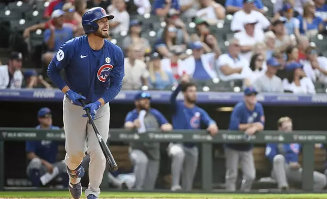 Chicago Cubs' Michael Busch reacts after hitting a one-run home run in the ninth inning of a baseball game against the Colorado Rockies, Sunday, Sept. 15, 2024, in Denver. (AP Photo/Geneva Heffernan)