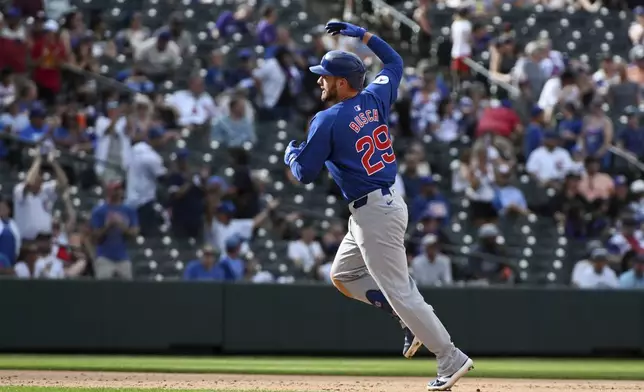 Chicago Cubs' Michael Busch celebrates while running the bases after hitting a one-run home run in the ninth inning of a baseball game against the Colorado Rockies, Sunday, Sept. 15, 2024, in Denver. (AP Photo/Geneva Heffernan)