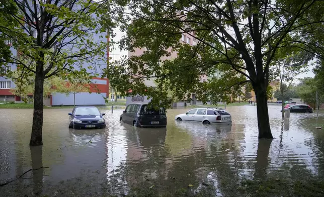 Vehicles are partially covered by water during floods in Ostrava, Czech Republic, Monday, Sept. 16, 2024. (AP Photo/Darko Bandic)