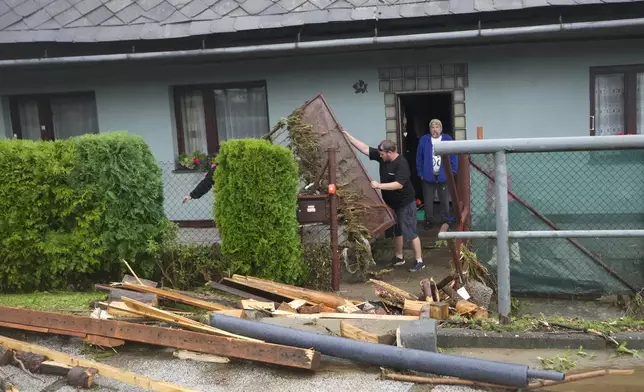 Residents clear their flooded house in Jesenik, Czech Republic, Sunday, Sept. 15, 2024. (AP Photo/Petr David Josek)