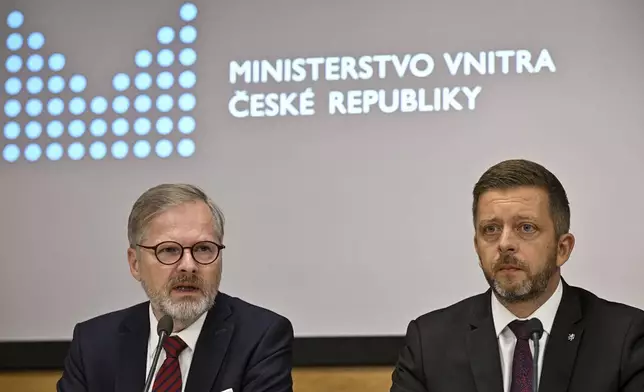 Czech Prime Minister Petr Fiala, left, speaks during a news conference after the meeting of Central Crisis Staff due to the risk of floods in Prague, Czech Republic, Friday, Sept. 13, 2024. At right is Czech Interior Minister Vit Rakusan. (Vit Simanek/CTK via AP)