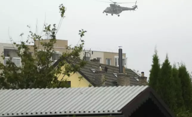 An army helicopter flies over the flooded Jesenik, Czech Republic, Sunday, Sept. 15, 2024. (AP Photo/Petr David Josek)