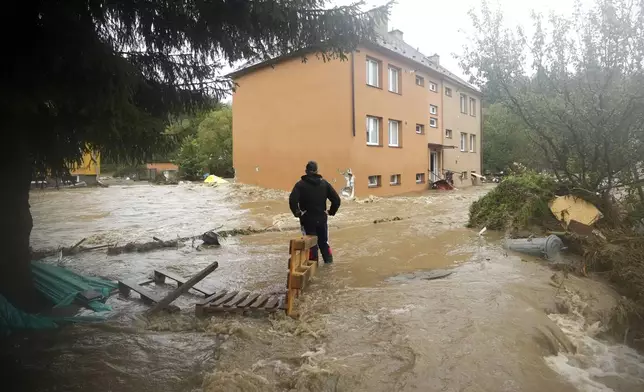 A resident looks at his flooded house in Jesenik, Czech Republic, Sunday, Sept. 15, 2024. (AP Photo/Petr David Josek)