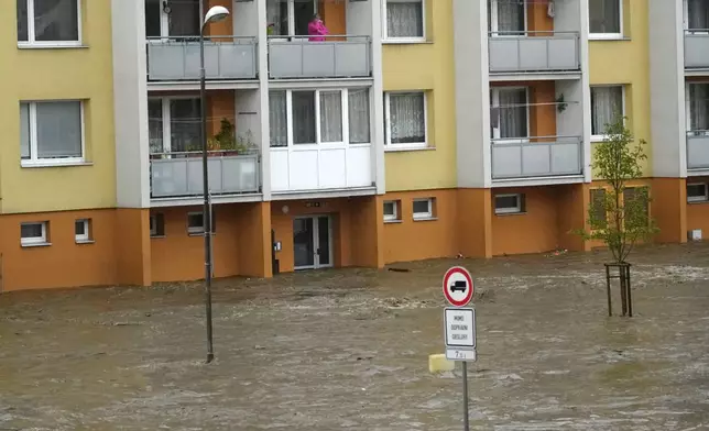 A resident looks at the flooded city center of Jesenik, Czech Republic, Sunday, Sept. 15, 2024. (AP Photo/Petr David Josek)