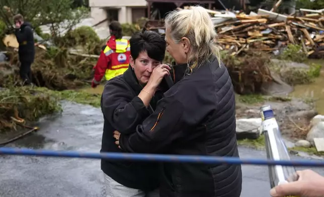 A resident hugs with her relative after being evacuated from her flooded house in Jesenik, Czech Republic, Sunday, Sept. 15, 2024. (AP Photo/Petr David Josek)