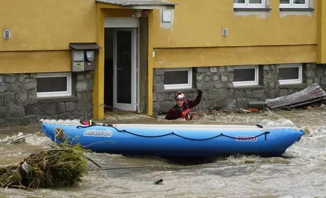 A rescue worker signals to his colleagues during an evacuation operation during floods in Jesenik, Czech Republic, Sunday, Sept. 15, 2024. (AP Photo/Petr David Josek)