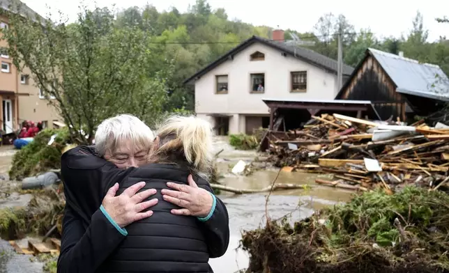 A resident hugs with her relative after being evacuated from her flooded house in Jesenik, Czech Republic, Sunday, Sept. 15, 2024. (AP Photo/Petr David Josek)