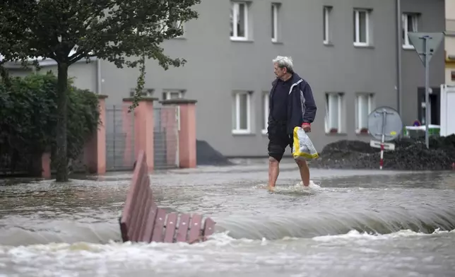 A resident walks through a flooded street in Liotvel, Czech Republic, Monday, Sept. 16, 2024. (AP Photo/Petr David Josek)