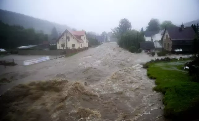 Flooded streets and houses in Jesenik, Czech Republic, Sunday, Sept. 15, 2024. (AP Photo/Petr David Josek)