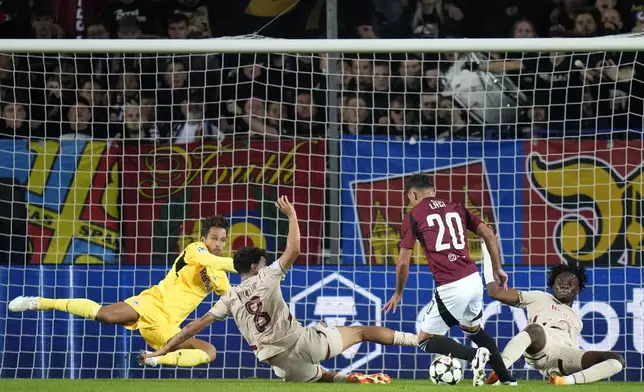 Sparta's Qazim Laci, center right, is about toscore his sides third goal past Salzburg's goalkeeper Janis Blaswich, left, during the Champions League opening phase soccer match between Sparta Prague and Salzburg in Prague, Czech Republic, Wednesday, Sept. 18, 2024. (AP Photo/Petr David Josek)