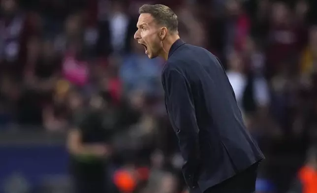 Salzburg's ead coach Pepijn Lijnders shuts from the touchline during the Champions League opening phase soccer match between Sparta Prague and Salzburg in Prague, Czech Republic, Wednesday, Sept. 18, 2024. (AP Photo/Petr David Josek)