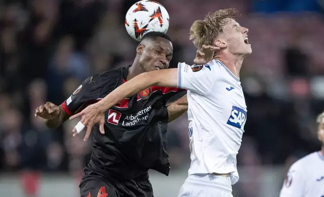 FC Midtjylland's Ousmane Diao, and Hoffenheim's Max Moerstedt battle for a head ball during a Europa League soccer match against FC Midtjylland at MCH Arena in Herning, Denmark, Wednesday, Sept. 25, 2024. (Bo Amstrup/Ritzau Scanpix via AP)