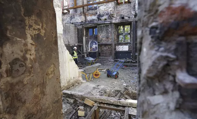 Workers clear rubble at Copenhagen's Old Stock Exchange building in Copenhagen, Denmark, Thursday, Sept. 19, 2024. (AP Photo James Brooks)