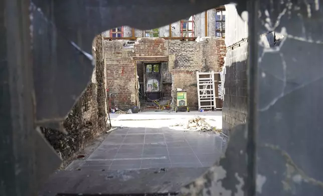 Remains of Copenhagen's Old Stock Exchange building are seen through a broken glass window in Copenhagen, Denmark, Thursday, Sept. 19, 2024. (AP Photo James Brooks)