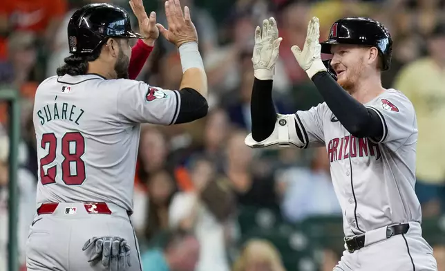 Arizona Diamondbacks' Pavin Smith, right, celebrates after his three-run home run against the Houston Astros with Eugenio Suarez during the second inning of a baseball game Sunday, Sept. 8, 2024, in Houston. (AP Photo/Eric Christian Smith)