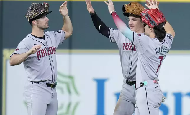 Arizona Diamondbacks' Randal Grichuk, left, Jake McCarthy, center, and Corbin Carroll celebrate the team's win over the Houston Astros in a baseball game Sunday, Sept. 8, 2024, in Houston. (AP Photo/Eric Christian Smith)