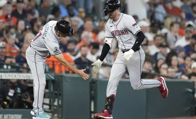 Arizona Diamondbacks' Pavin Smith, right, celebrates after his three-run home run against the Houston Astros with third base coach Tony Perezchica during the second inning of a baseball game Sunday, Sept. 8, 2024, in Houston. (AP Photo/Eric Christian Smith)