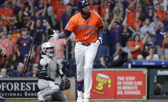 Houston Astros' Yordan Alvarez (44) flips his bat as he watches his three-run home run in front of Arizona Diamondbacks catcher Jose Herrera, left, during the fifth inning of a baseball game Friday, Sept. 6, 2024, in Houston. (AP Photo/Michael Wyke)