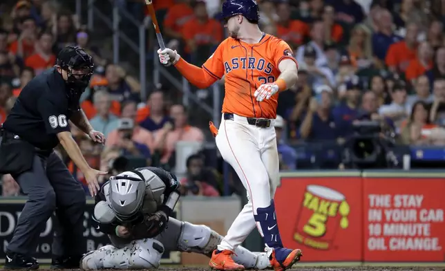 Umpire Mark Ripperger (90) reaches for Arizona Diamondbacks catcher Jose Herrera, center, who was hit in the head on the backswing by Houston Astros designated hitter Kyle Tucker, right, during the fifth inning of a baseball game Friday, Sept. 6, 2024, in Houston. (AP Photo/Michael Wyke)