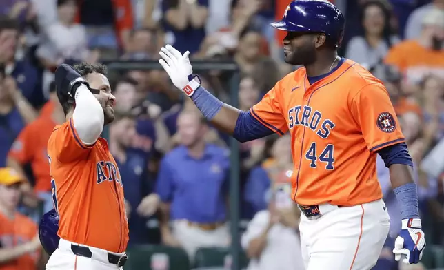 Houston Astros' Jose Altuve, left, and Yordan Alvarez (44) celebrate after they scored on Alvarez's second three-run home run of a baseball game against the Arizona Diamondbacks during the sixth inning Friday, Sept. 6, 2024, in Houston. (AP Photo/Michael Wyke)