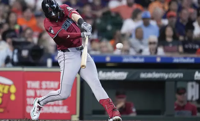 Arizona Diamondbacks' Kevin Newman hits an RBI single against the Houston Astros during the second inning of a baseball game, Saturday, Sept. 7, 2024, in Houston. (AP Photo/Eric Christian Smith)