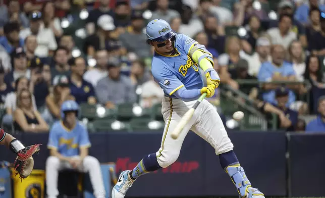 Milwaukee Brewers' William Contreras hits a three-run home run during the fifth inning of a baseball game against the Arizona Diamondbacks, Friday, Sept. 20, 2024, in Milwaukee. (AP Photo/Jeffrey Phelps)