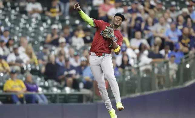 Arizona Diamondbacks shortstop Geraldo Perdomo throws late to first base on a hit by Milwaukee Brewers' Jackson Chourio during the fifth inning of a baseball game Friday, Sept. 20, 2024, in Milwaukee. (AP Photo/Jeffrey Phelps)