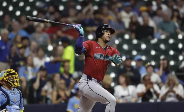 Arizona Diamondbacks second base Ketel Marte watches his home run during the first inning of a baseball game against the Milwaukee Brewers Friday, Sept. 20, 2024, in Milwaukee. (AP Photo/Jeffrey Phelps)