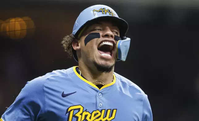 Milwaukee Brewers' William Contreras reacts after hitting a three-run home run during the fifth inning of a baseball game against the Arizona Diamondbacks, Friday, Sept. 20, 2024, in Milwaukee. (AP Photo/Jeffrey Phelps)