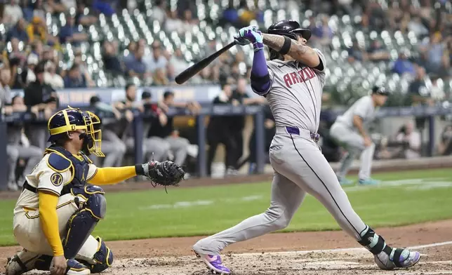 Arizona Diamondbacks' Ketel Marte hits an RBI single during the fifth inning of a baseball game against the Milwaukee Brewers Thursday, Sept. 19, 2024, in Milwaukee. (AP Photo/Morry Gash)