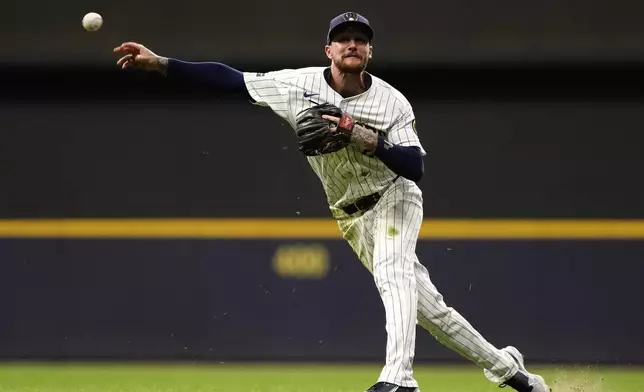 Milwaukee Brewers' Brice Turang throws a runner out at first base during the eighth inning of a baseball game against the Arizona Diamondbacks, Saturday, Sept. 21, 2024, in Milwaukee. (AP Photo/Aaron Gash)