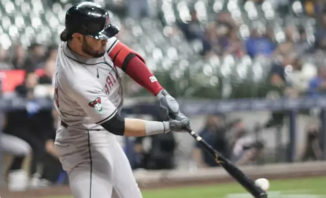 Arizona Diamondbacks' Eugenio Suárez hits a single during the fourth inning of a baseball game against the Milwaukee Brewers Thursday, Sept. 19, 2024, in Milwaukee. (AP Photo/Morry Gash)