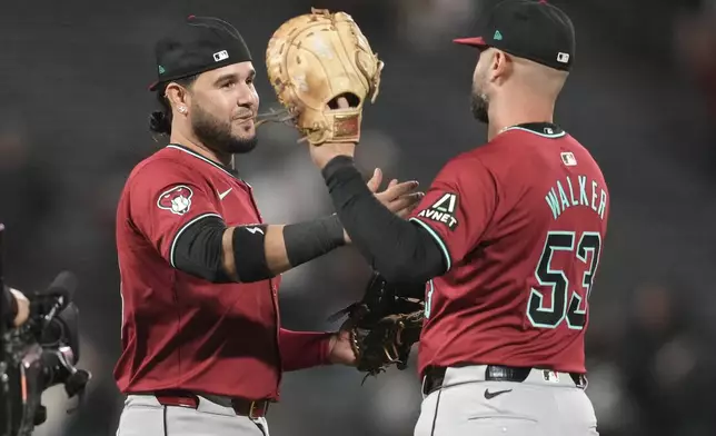 Arizona Diamondbacks' Eugenio Suárez, left, celebrates with Christian Walker after the Diamondbacks defeated the San Francisco Giants in a baseball game in San Francisco, Wednesday, Sept. 4, 2024. (AP Photo/Jeff Chiu)