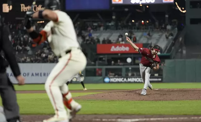 Arizona Diamondbacks pitcher Zac Gallen, right, pitches to San Francisco Giants' Michael Conforto during the sixth inning of a baseball game in San Francisco, Wednesday, Sept. 4, 2024. (AP Photo/Jeff Chiu)