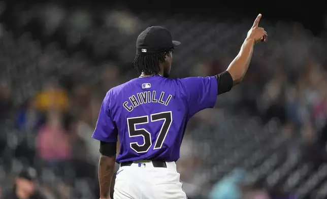 Colorado Rockies relief pitcher Angel Chivilli gestures after getting Arizona Diamondbacks' Corbin Carroll to pop out to end a baseball game, Tuesday, Sept. 17, 2024, in Denver. (AP Photo/David Zalubowski)