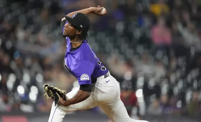 Colorado Rockies relief pitcher Angel Chivilli works against the Arizona Diamondbacks in the ninth inning of a baseball game Tuesday, Sept. 17, 2024, in Denver. (AP Photo/David Zalubowski)