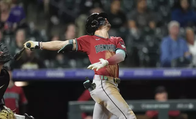 Arizona Diamondbacks' Corbin Carroll pops out against Colorado Rockies relief pitcher Angel Chivilli to end a baseball game Tuesday, Sept. 17, 2024, in Denver. (AP Photo/David Zalubowski)