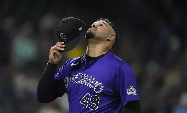 Colorado Rockies starting pitcher Antonio Senzatela heads to the dugout after being pulled form the mound in the fourth inning of a baseball game against the Arizona Diamondbacks, Monday, Sept. 16, 2024, in Denver. (AP Photo/David Zalubowski)