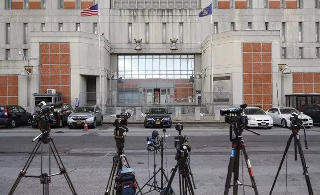 FILE - Media outlets set up cameras outside the main entrance of the Metropolitan Detention Center Tuesday, July 14, 2020, in the Brooklyn borough of New York. (AP Photo/John Minchillo, File)