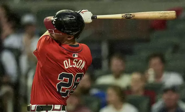 Atlanta Braves' Matt Olson (28) hits an RBI-double against the Los Angeles Dodgers inning of a baseball game, Friday, Sept. 13, 2024, in Atlanta. (AP Photo/Mike Stewart)