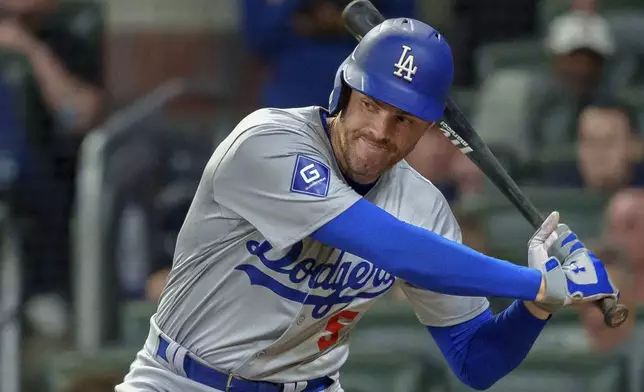 Los Angeles Dodgers' Freddie Freeman swings in the fourth inning of a baseball game against the Atlanta Braves, Monday, Sept. 16, 2024, in Atlanta. (AP Photo/Jason Allen)