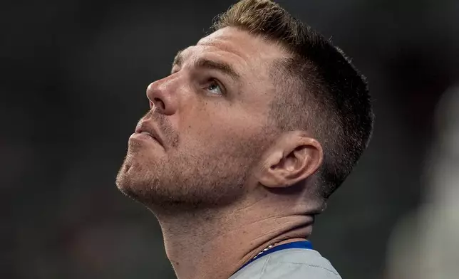 Los Angeles Dodgers first baseman Freddie Freeman (5) watches a fly ball from the dugoput in the fourth inning of a baseball game against the Atlanta Braves, Friday, Sept. 13, 2024, in Atlanta. (AP Photo/Mike Stewart)