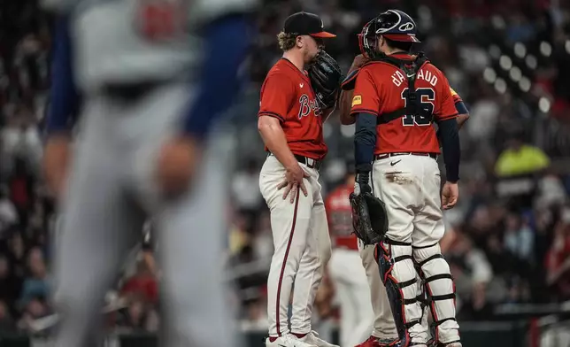 Atlanta Braves pitcher Spencer Schwellenbach (56) speaks with catcher Travis d'Arnaud on the mound in the fourth inning of a baseball game against the Los Angeles Dodgers, Friday, Sept. 13, 2024, in Atlanta. (AP Photo/Mike Stewart)